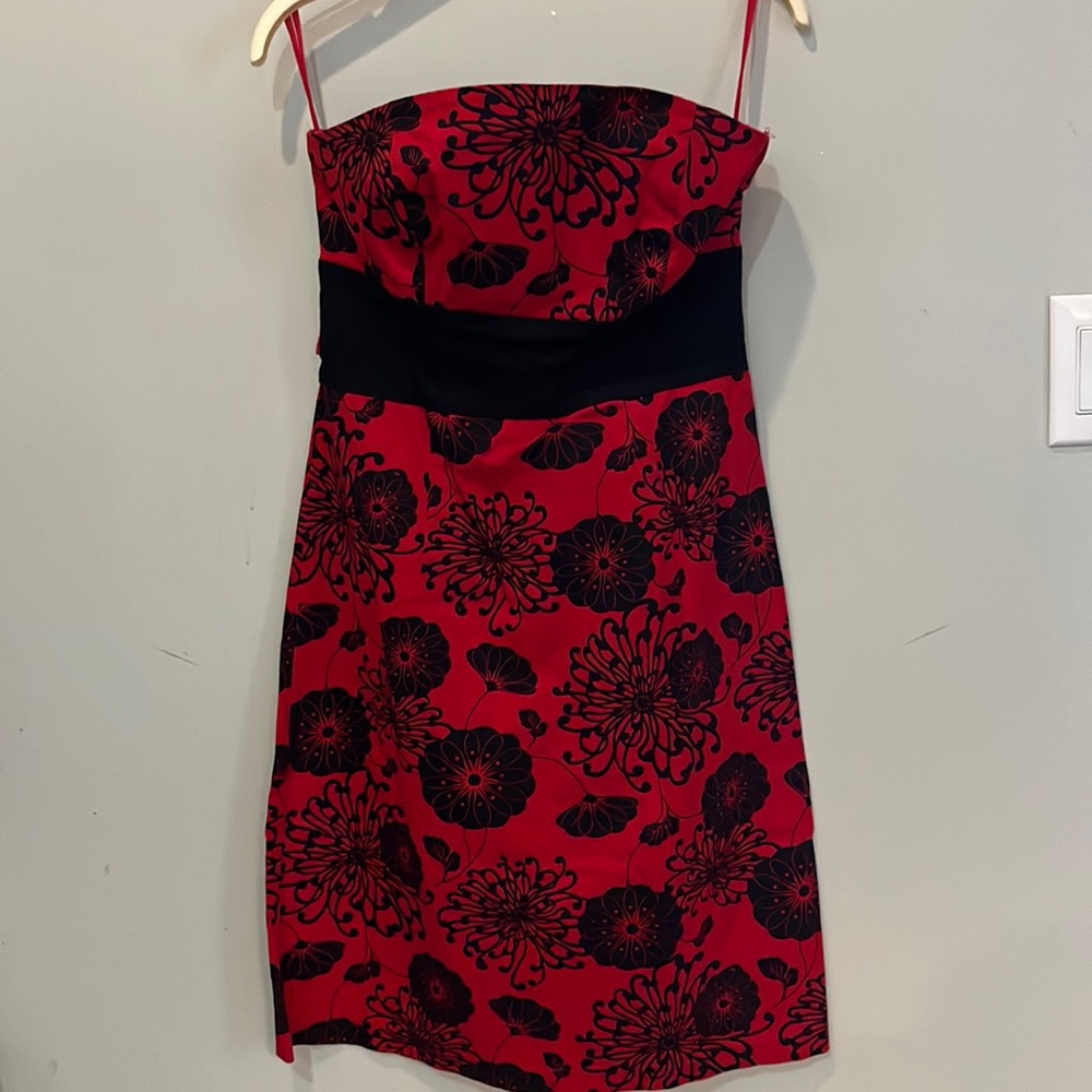 Cute strapless a-line mini dress. Red with black flowers and ties at the back.